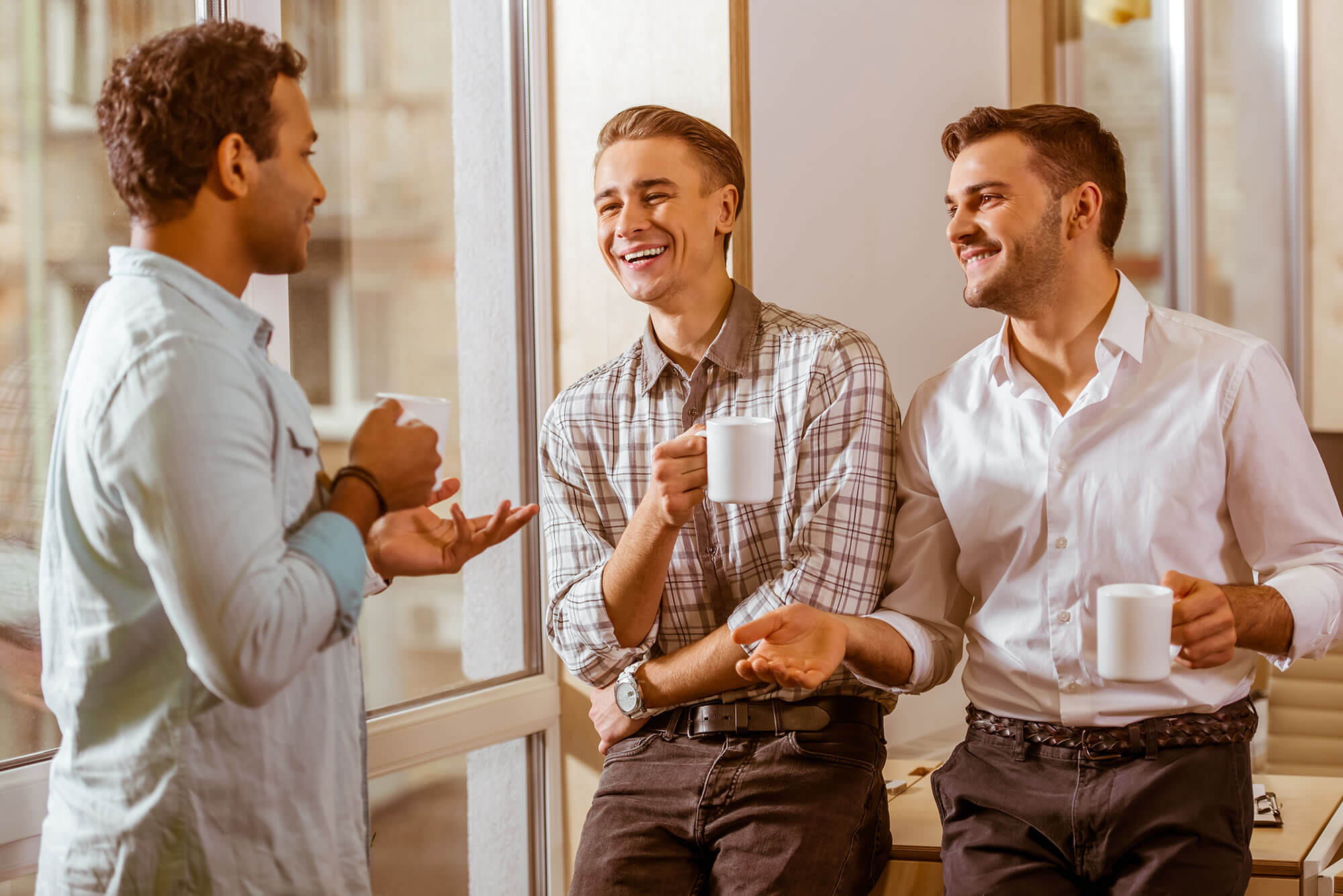 three men stand office discuss
